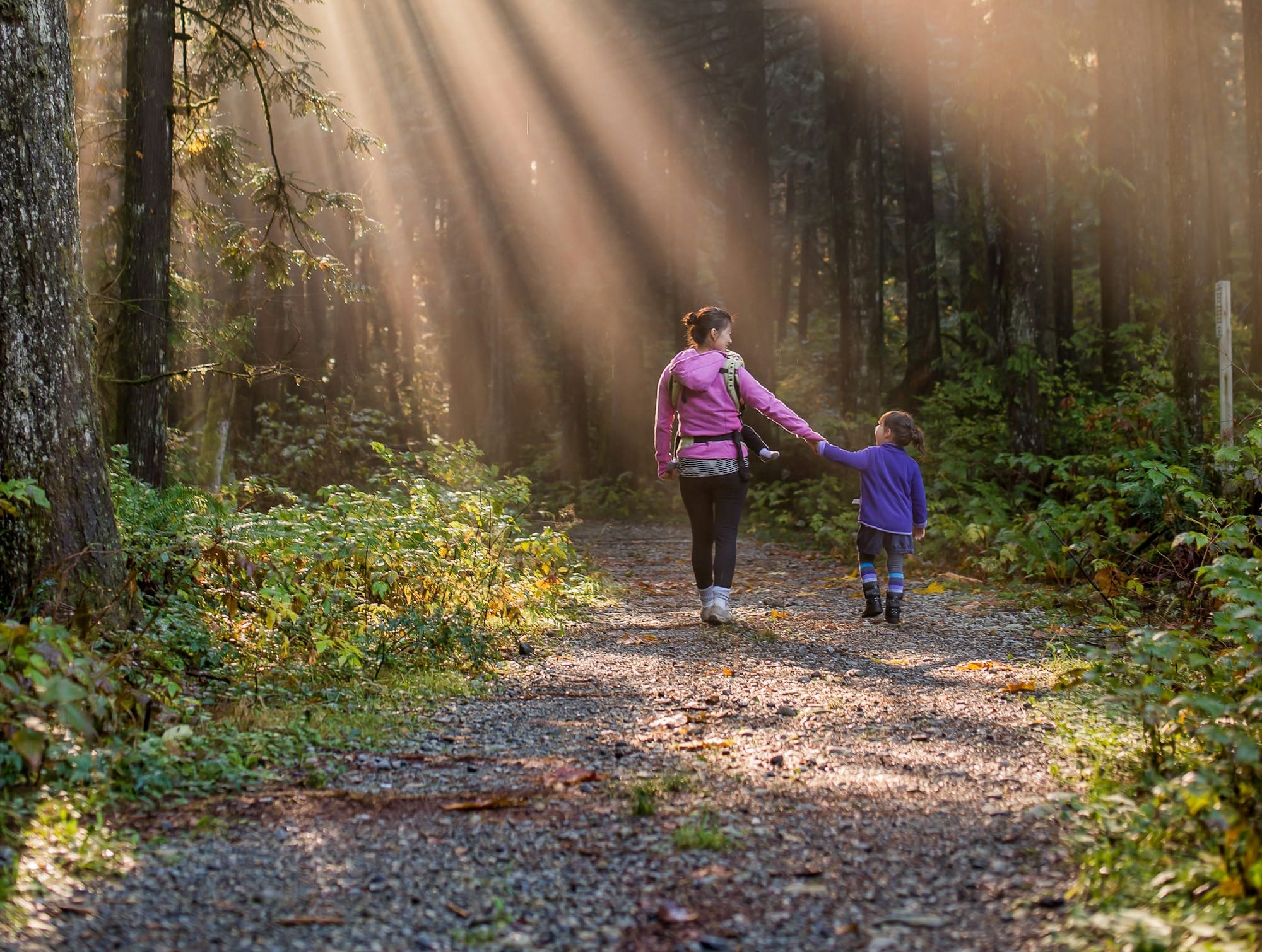 woman walking in forest with child