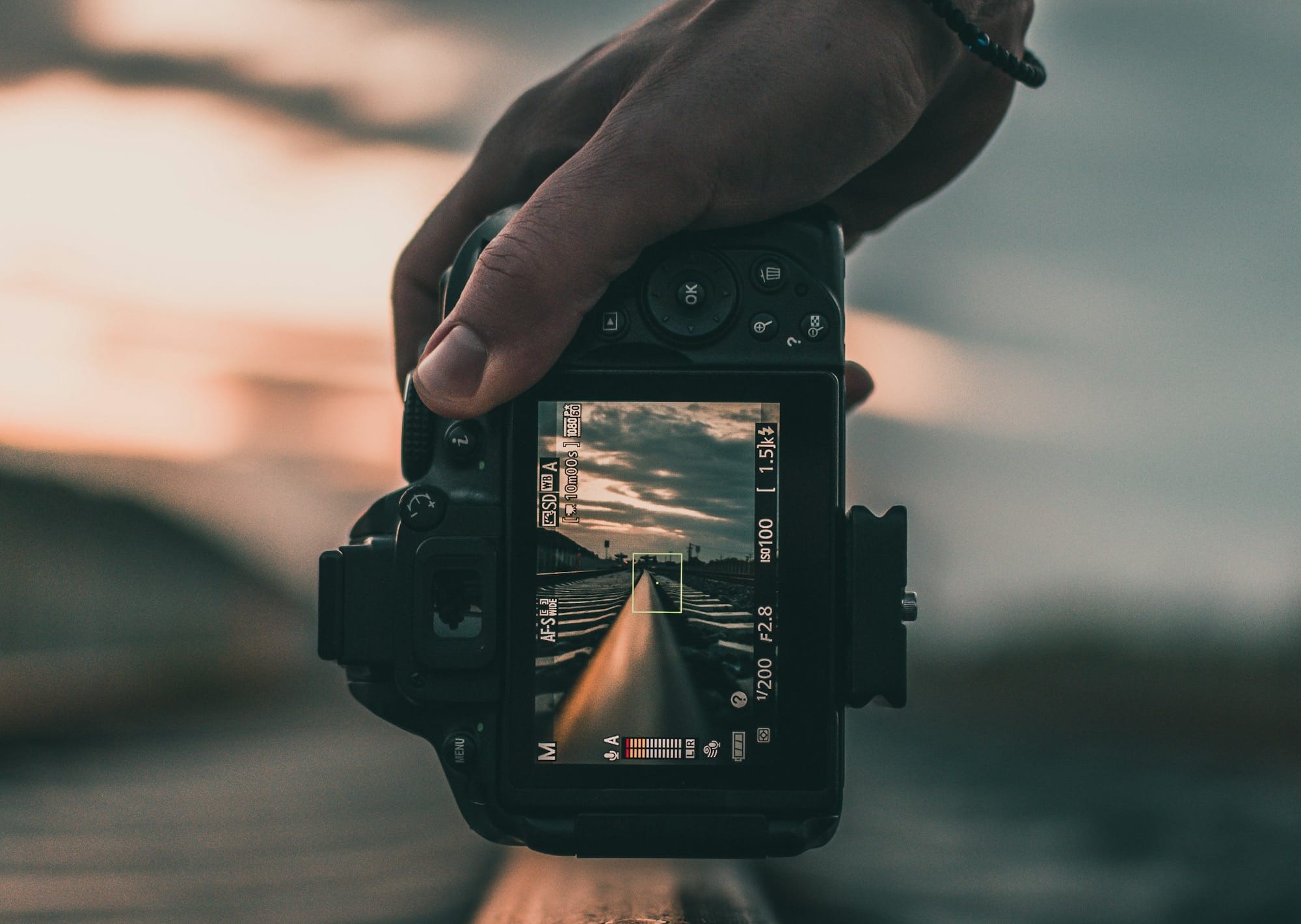 person holding black dslr camera during daytime