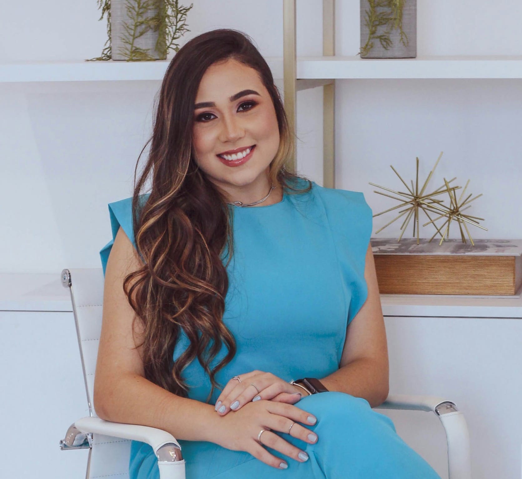 a woman sitting in a chair with her legs crossed